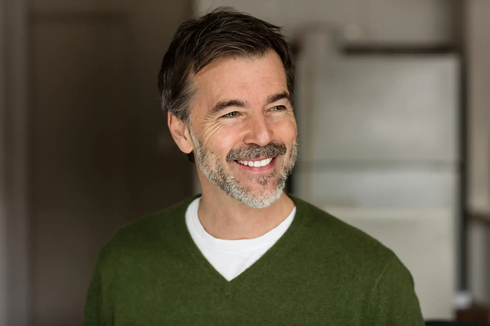 Mature Businessman Smiling and Looking Away. Isolated On the kitchen
