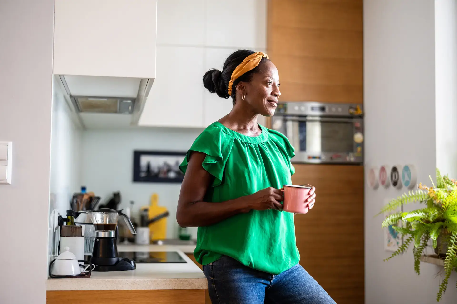 Portrait of a smiling mature woman standing in her kitchen