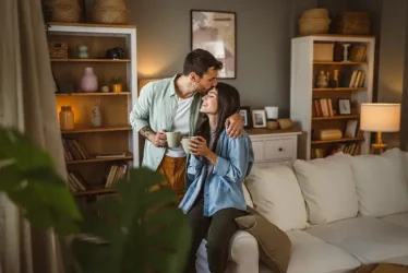 Boyfriend and girlfriend drink coffee and enjoy at home